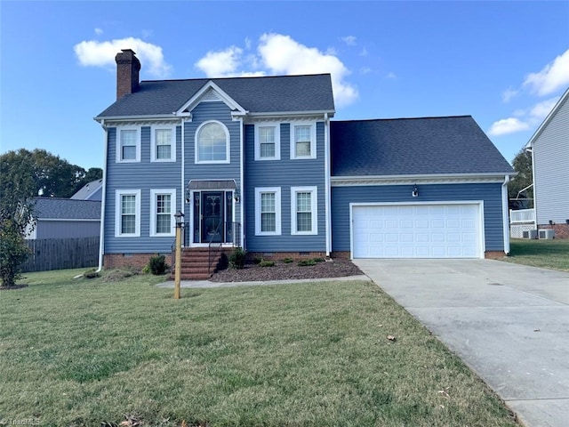 colonial-style house featuring a garage and a front lawn