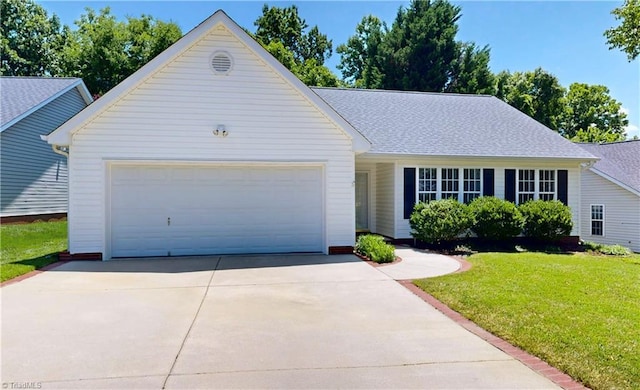 5423 Whitley Way, Greensboro, NC 27407 - view of front of house with a front lawn, an attached garage, concrete driveway, and roof with shingles