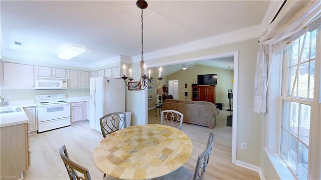 5423 Whitley Way, Greensboro, NC 27407 - dining area featuring light wood-style flooring, a chandelier, crown molding, and vaulted ceiling