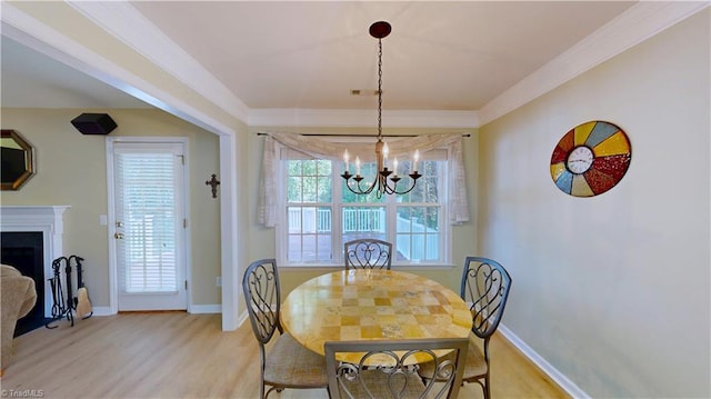 5423 Whitley Way, Greensboro, NC 27407 - dining space with a chandelier, light wood-type flooring, crown molding, and a fireplace