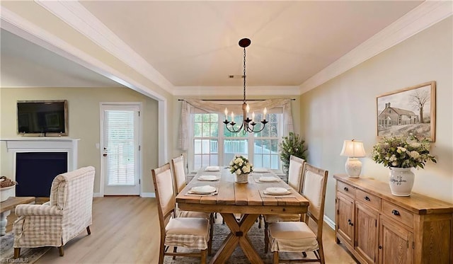 5423 Whitley Way, Greensboro, NC 27407 - dining area featuring ornamental molding, a chandelier, light wood-style floors, and a fireplace