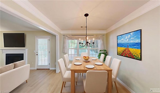 5423 Whitley Way, Greensboro, NC 27407 - dining space with a chandelier, crown molding, light wood finished floors, and a fireplace