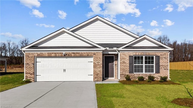 view of front of property with a front yard, concrete driveway, brick siding, and an attached garage