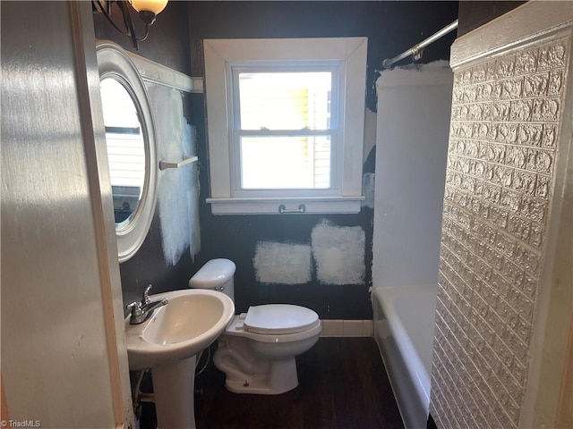 bathroom featuring hardwood / wood-style flooring and toilet