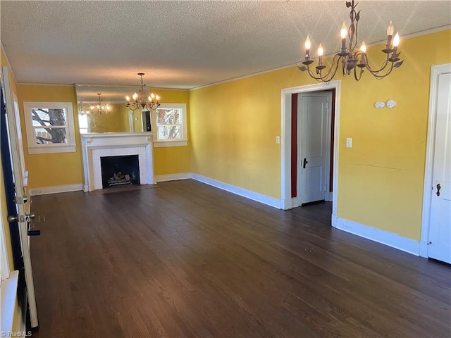 unfurnished living room with a fireplace, dark hardwood / wood-style flooring, a healthy amount of sunlight, and a textured ceiling