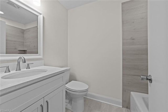 full bath with vanity, a bath, visible vents, baseboards, and toilet