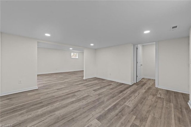 basement with recessed lighting, wood finished floors, visible vents, and baseboards