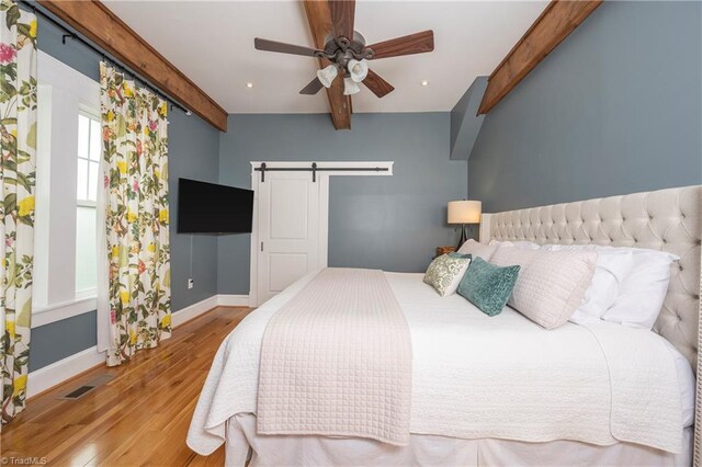 229 Orchard St, Mount Airy, NC 27030 - bedroom featuring a barn door, wood finished floors, beamed ceiling, baseboards, and recessed lighting
