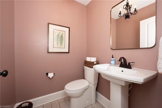 229 Orchard St, Mount Airy, NC 27030 - bathroom with baseboards, toilet, and a chandelier