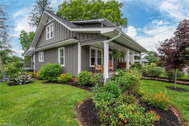 229 Orchard St, Mount Airy, NC 27030 - view of front of house featuring board and batten siding, a porch, and a front yard