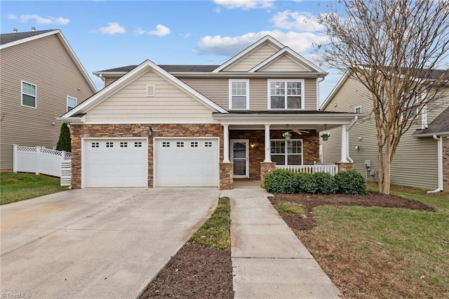 craftsman house with fence, a porch, concrete driveway, a garage, and stone siding