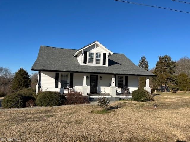 view of front of home with a front yard and a porch