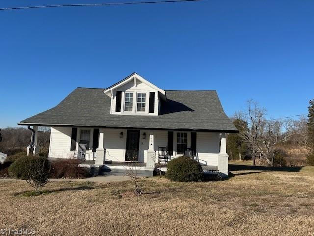 view of front of home featuring a front lawn and a porch