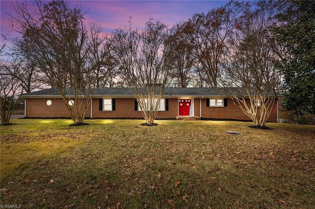 ranch-style house with a yard