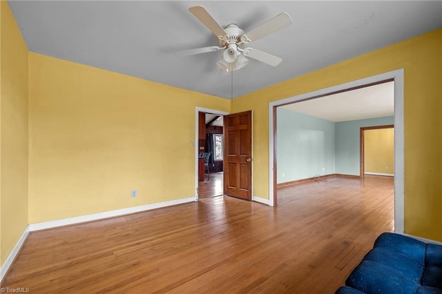 empty room with light wood-type flooring and ceiling fan