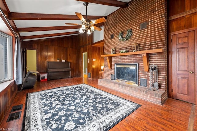 living room with lofted ceiling with beams, wood-type flooring, and wooden walls