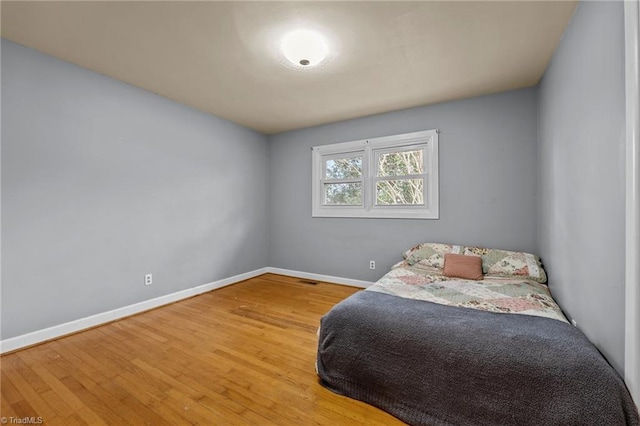 bedroom with wood-type flooring