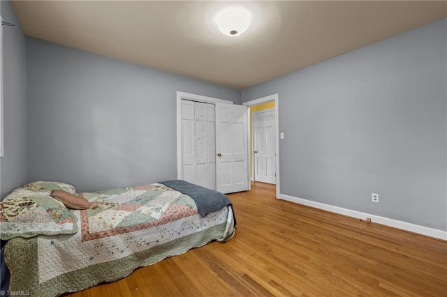 bedroom featuring hardwood / wood-style flooring and a closet