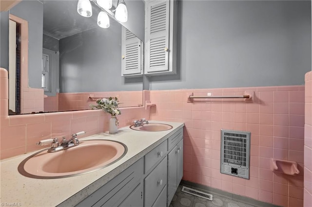 bathroom featuring vanity, tile walls, and heating unit