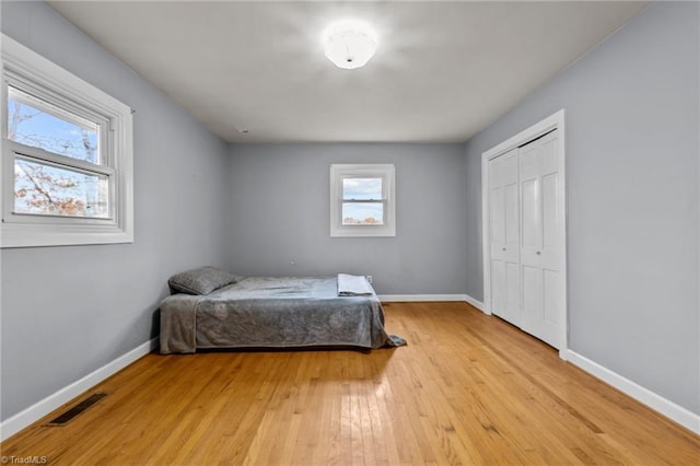 bedroom featuring a closet and light wood-type flooring