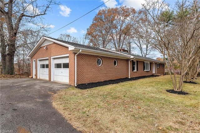 view of property exterior featuring a garage and a yard