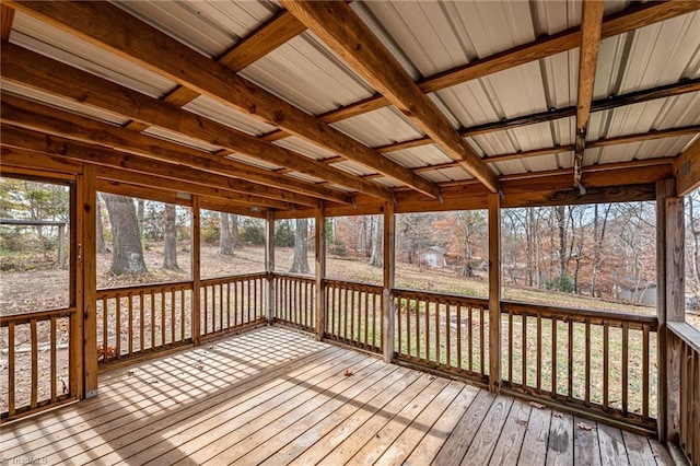 unfurnished sunroom featuring beam ceiling, wooden ceiling, and a healthy amount of sunlight