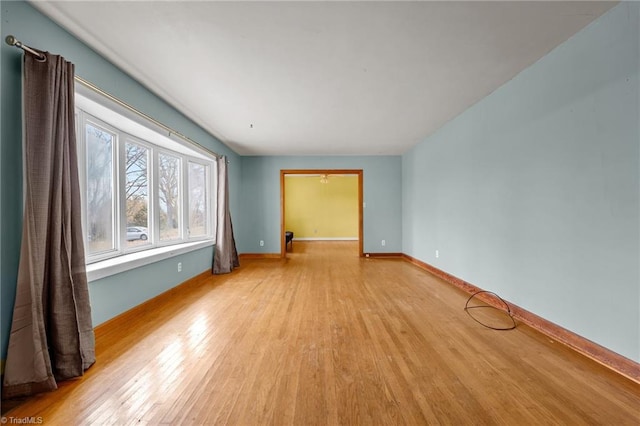 unfurnished room with light wood-type flooring