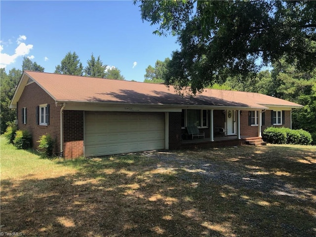 ranch-style house with a garage and covered porch