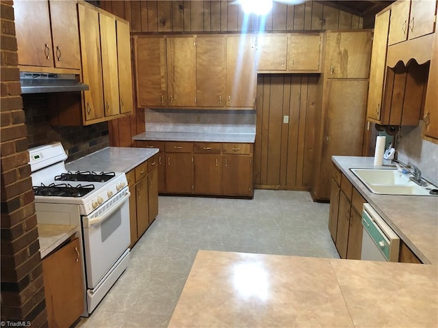 kitchen featuring white appliances, sink, and tasteful backsplash