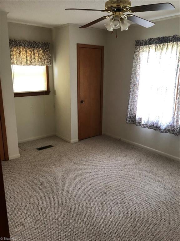 spare room with ceiling fan and carpet flooring