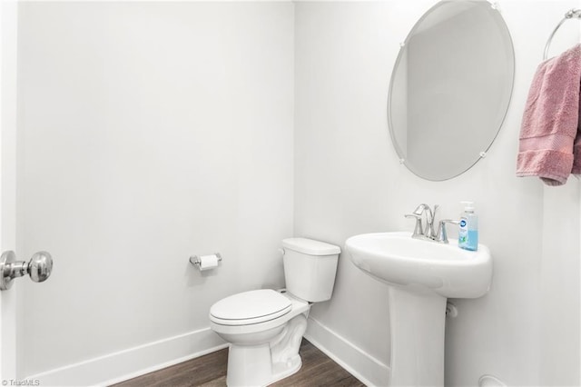 bathroom featuring hardwood / wood-style flooring, toilet, and sink