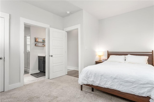 carpeted bedroom with connected bathroom