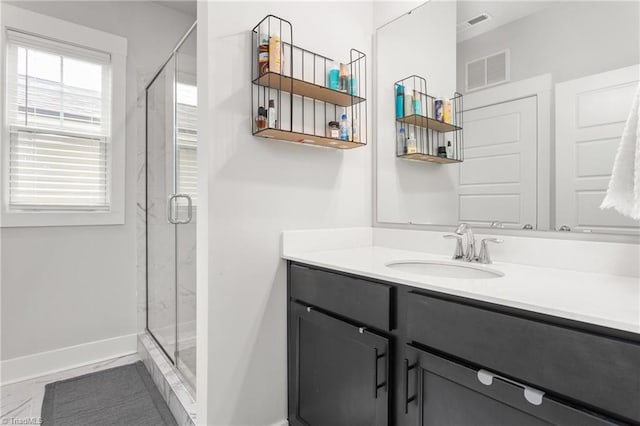 bathroom featuring vanity and a shower with door