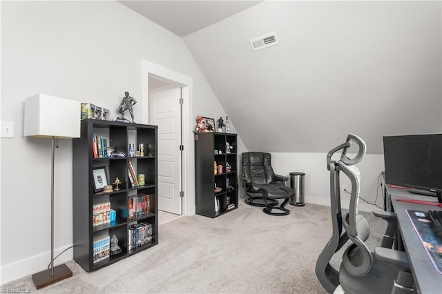 carpeted office featuring vaulted ceiling