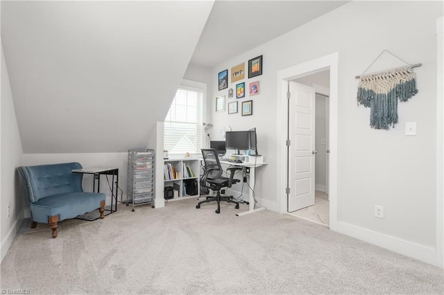 carpeted office featuring vaulted ceiling