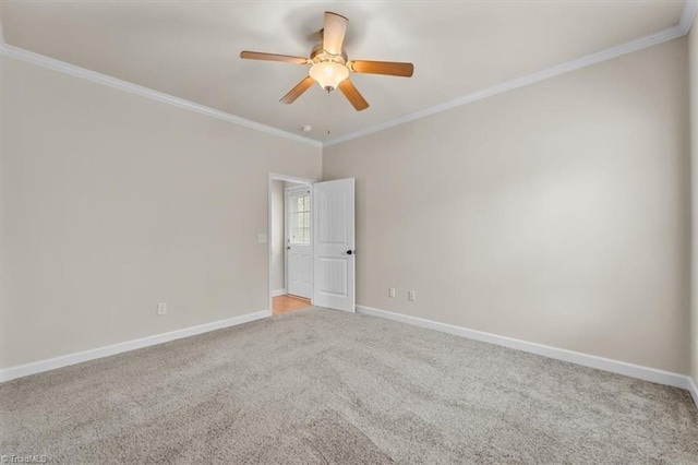 empty room with ceiling fan, crown molding, baseboards, and light carpet