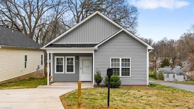 bungalow-style house with a front lawn and driveway