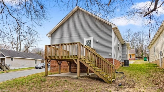 rear view of house with stairs, a lawn, central AC, and a wooden deck