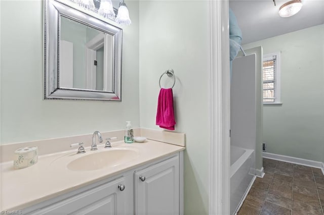 full bathroom with vanity and baseboards