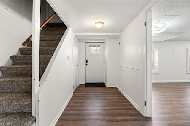 interior space featuring stairs, dark wood-style floors, and baseboards