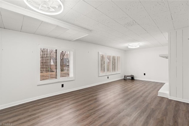 unfurnished room featuring wood finished floors and baseboards