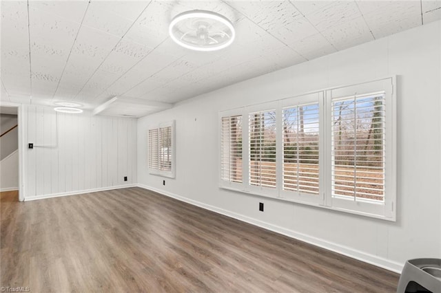 interior space with wood finished floors and baseboards