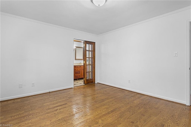 spare room with hardwood / wood-style floors and ornamental molding