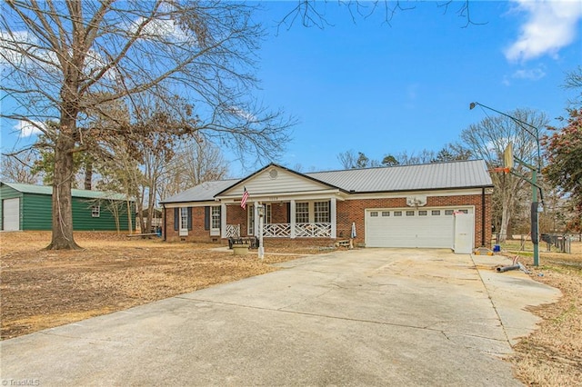 single story home with a garage and covered porch