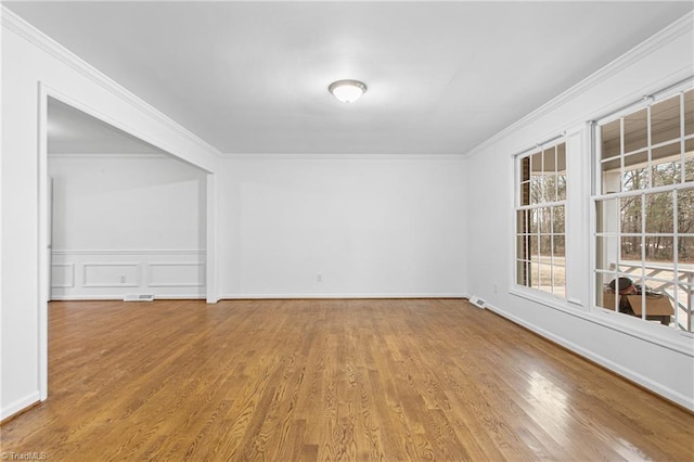 unfurnished room featuring light hardwood / wood-style floors and ornamental molding