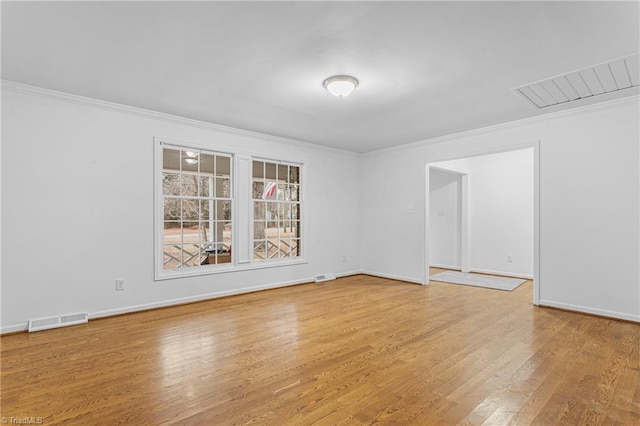 unfurnished room with hardwood / wood-style flooring and crown molding