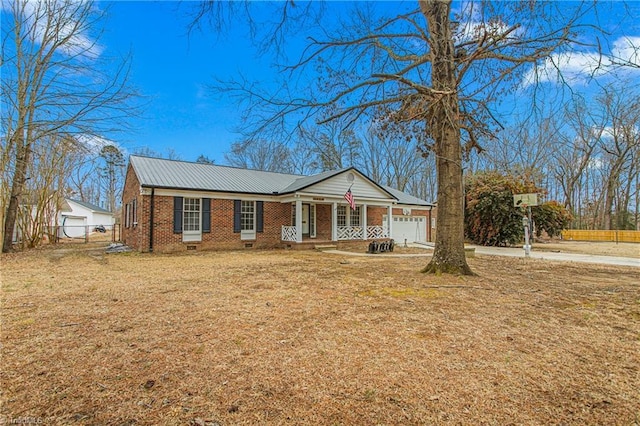 ranch-style home with a porch, a garage, and a front lawn