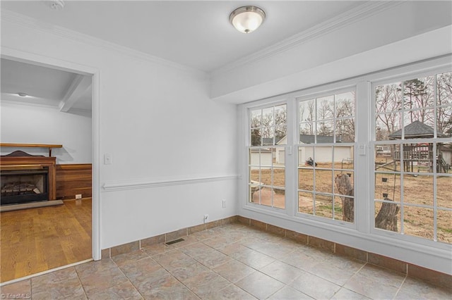 dining area with ornamental molding and light tile patterned floors