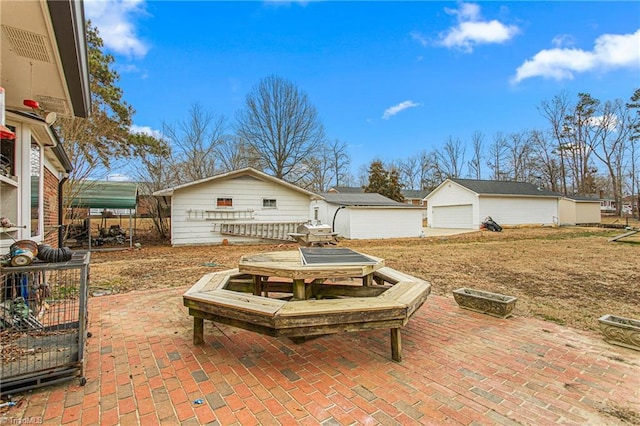 view of patio / terrace with an outdoor structure and a garage