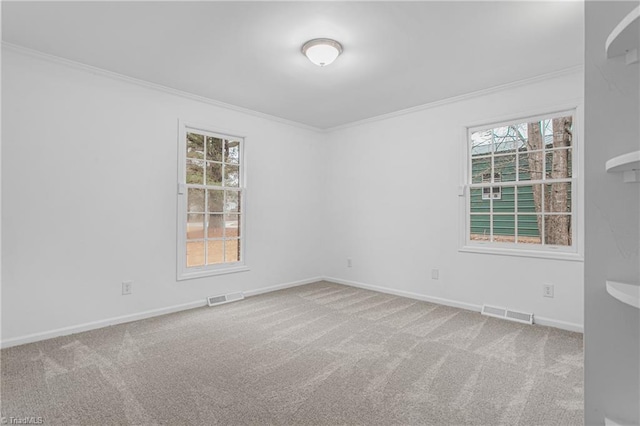 carpeted empty room with plenty of natural light and ornamental molding